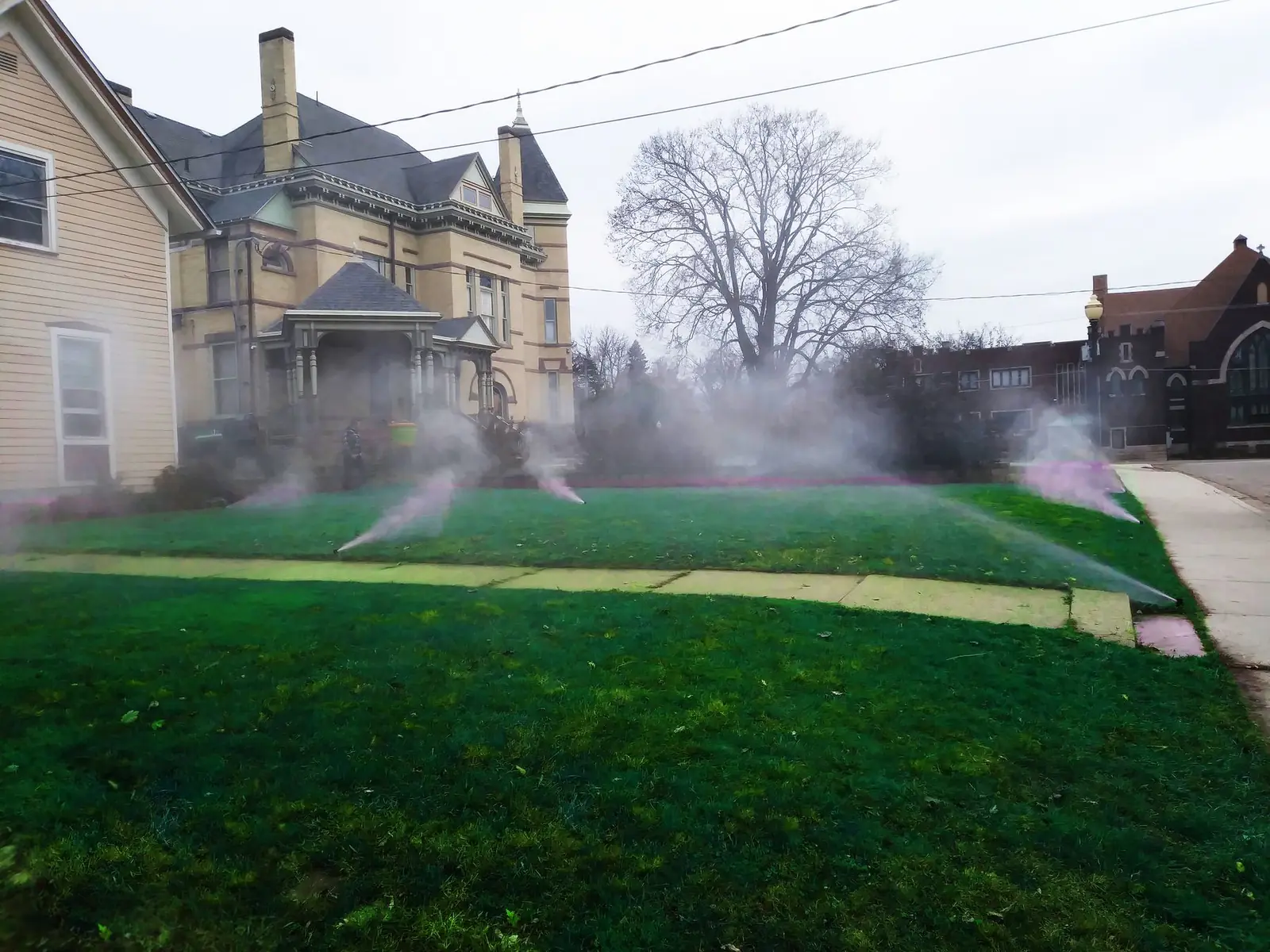 Sprinklers watering a property